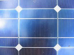 Combined light communication and energy harvesting from solar panel receivers